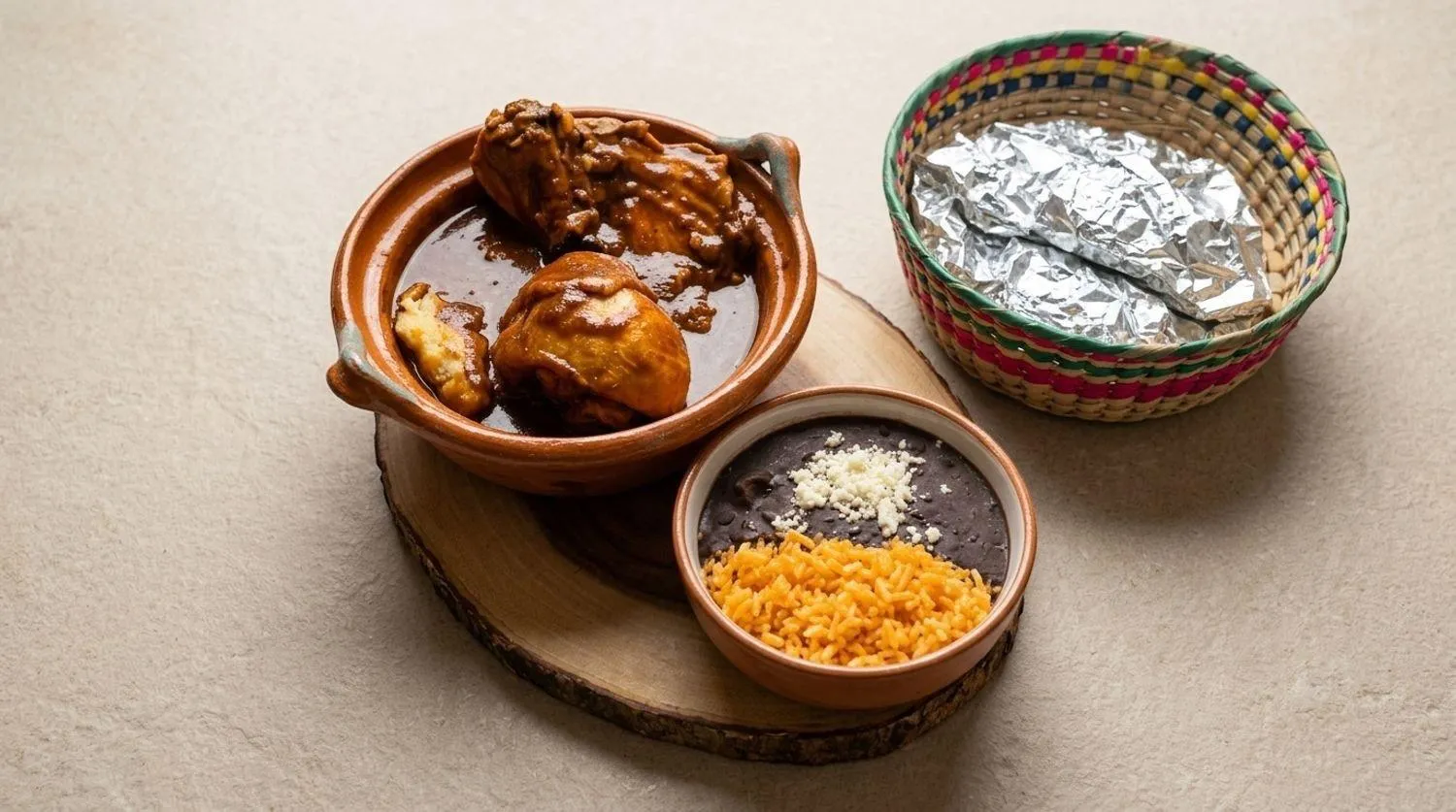 Chicken mole served with rice, beans and tortillas